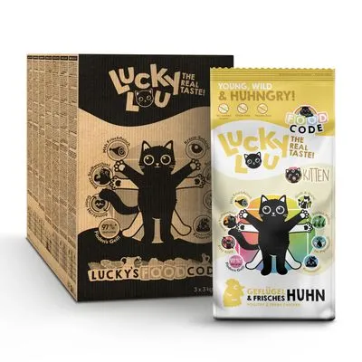 Lucky Lou The Real Taste! Kitten kattenvoer, verpakking met cartoonkat en tekst: Geflügel & frisches Huhn. Bevat symbolen en voedingsinformatie op de doos.
