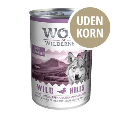 Wolf of Wilderness Wild Hills dåse, 100 % grain-free, uden korn, and med skovbær, rødder og vilde urter, 400 g. Tekst på engelsk og tysk synlig.