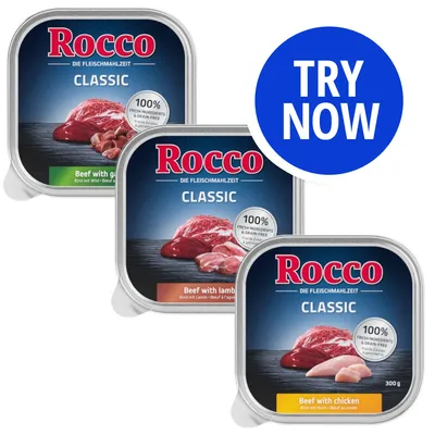 Three Rocco Classic trays: beef with game, beef with lamb, and beef with chicken. Each states 100% fresh ingredients and grain-free. Blue circle with white text reads 'TRY NOW'.