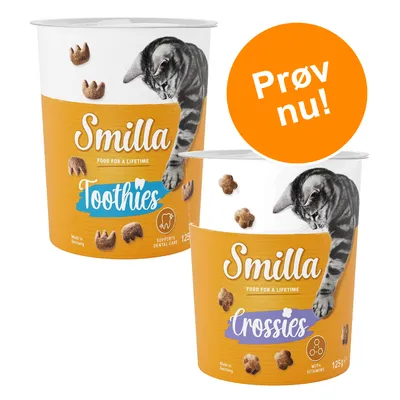 To bøtter Smilla kattegodbidder: Toothies 125 g 'Supports dental care' og Crossies 125 g 'With vitamins'. Orange cirkel med teksten 'Prøv nu!'.