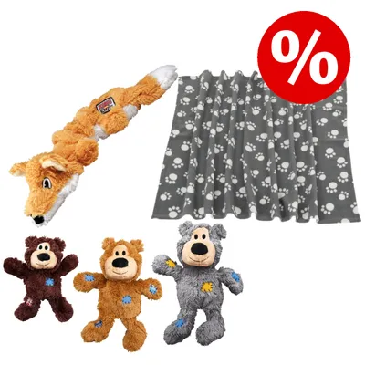 Plüschspielzeug in Fuchs- und Bärenform sowie graue Decke mit weißen Pfotenabdrücken, rotes Prozentzeichen für Rabattaktion sichtbar.