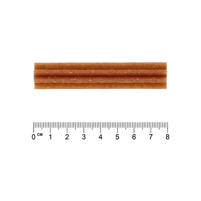 Barna rágcsálnivaló bordázott felülettel, hossza kb. 7 cm, méretmegadás céljából vonalzó mellett ábrázolva.