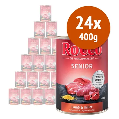 Rocco Senior Lamb & millet, confezione da 24 lattine da 400 g. Testo visibile: 'Supporting Power & Vitality', 'Die Fleischmahlzeit'. Immagine di carne e miglio sulla lattina.