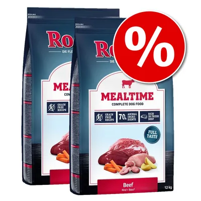 2 sacos de pienso para perros Mealtime Beef 12 kg, texto visible: 'Grain free recipe', '7% animal ingredients', 'Rich in fresh beef', oferta destacada con símbolo de porcentaje.