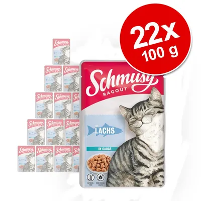 Schmusy Ragout Lachs in Sauce, 22 x 100 g. Opakowanie z wizerunkiem kota i kawałkami łososia. Widoczne oznaczenia: bez zbóż, bez dodatku cukru.