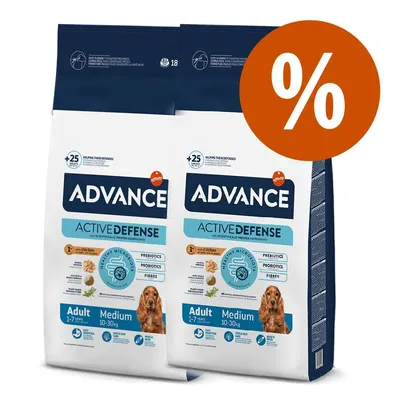 Dos sacos de pienso Advance Active Defense Adult Medium 10–30 kg, visible texto: prebióticos, probióticos, fibras, con pollo. Sello de oferta con símbolo de porcentaje.