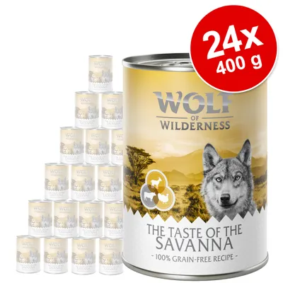 Wolf of Wilderness The Taste of the Savanna, 24x400 g, 100% grain-free recipe, conserve cu peisaj de savană și animale stilizate pe etichetă.