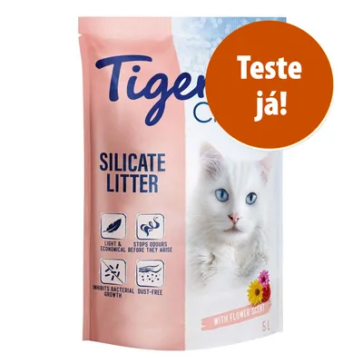 Embalagem Tigerino Silicate Litter, areia de sílica para gatos, com texto em inglês sobre benefícios e selo laranja com 'Teste já!'. Capacidade: 5L. Aroma floral visível. Embalagem Tigerino Silicate Litter, areia de sílica para gatos, com texto em inglês sobre benefícios e selo laranja com 'Teste já!'. Capacidade: 5L. Aroma floral visível.