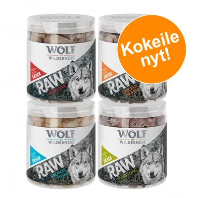 Wolf of Wilderness RAW Freeze Dried Snack: Beef Liver, Chicken Hearts, Salmon Fillet, Lamb Lung. Oranssi ympyrä tekstillä 'Kokeile nyt!'.