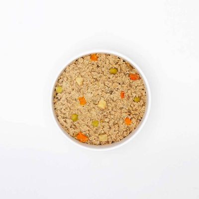 Bowl containing moist pet food with visible chunks of vegetables such as carrots and peas, showing texture and ingredients for product identification.