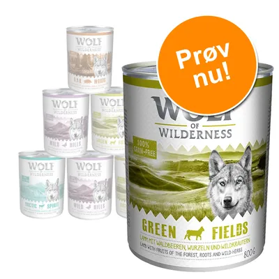 Wolf of Wilderness dåsefoder, variant Green Fields 800 g med teksten '100% grain-free' og orange mærke 'Prøv nu!'. Flere varianter synlige: Oak Woods, Wild Hills, Arctic Spirit.