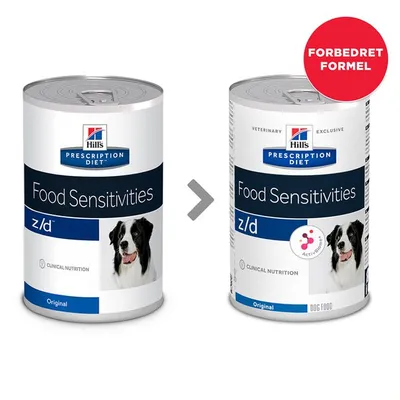 To konservdåser Hill's Prescription Diet Food Sensitivities z/d Original med hundebillede. Højre dåse har rød cirkel med teksten 'FORBEDRET FORMEL' og ekstra mærke 'ActivBiome+'. To konservdåser Hill's Prescription Diet Food Sensitivities z/d Original med hundebillede. Højre dåse har rød cirkel med teksten 'FORBEDRET FORMEL' og ekstra mærke 'ActivBiome+'.