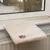 Beige windowsill mat with soft surface and embroidered paw motif, suitable for radiators under the windowsill.