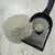 Cat litter with clumping, shown with black litter scoop on light background.