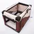 Soft-sided pet carrier in beige and brown fabric with mesh windows, zip openings on the front and side, black handles, and a removable mat inside. No visible brand name.