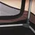 Close-up of a mesh window and sturdy metal frame corner inside a pet carrier or crate, showing ventilation and construction details.