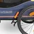 Hafenbande bicycle trailer with blue fabric, orange accents and black tyre with reflector.
