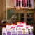 Dog indoors with fireworks outside, next to Beaphar CaniComfort calming products for stressful situations, including diffuser, spot-on and collar. Packaging highlights stress relief features.
