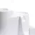 Close-up of a white plastic container with two separate compartments, showing the product’s divided design.