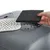 Hand showing activated carbon filter and perforated cover for air circulation on grey plastic housing.