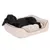 Cama rectangular beige para perros con borde elevado y cojín interior, mostrada con un perro negro tumbado encima. Material textil visible en toda la superficie.