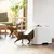 Cats using a white litter box with side entrance in a modern living space.