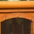 Close-up of a wooden pet house door with a transparent plastic flap and star-shaped fasteners at the top.