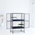 Grande cage en métal bleu à deux niveaux avec rampes et plateformes, portes ouvertes, sur roulettes. Convient pour rongeurs ou petits animaux, accessoires non inclus visibles.