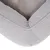 Close-up of a grey pet bed with soft padding and fabric cover.