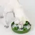 Dog eating from a green anti-gulping bowl with bone-shaped obstacles, designed to slow down food intake.