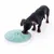 Dog eating from a green food dispenser with multiple compartments. Product shows interactive feeding method.
