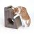 Brown scratching furniture made of cardboard with a round entrance and slanted scratching surface, demonstrated by a red and white cat.