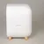 White container with rounded corners and wooden feet, side handle opening visible.