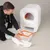 Demonstration of cleaning a white kooa cat litter box with pull-out drawer and orange frame.