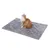 Grey blanket made of soft material with a red and white cat sitting on it. Product for pets.