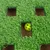 Toy with green artificial grass and yellow ball in a hole. Encourages interactive play through hiding and searching.