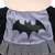 Design in tessuto grigio con logo Batman nero, parte di un costume o accessorio.