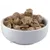 White bowl with brown, dried food pieces. Product image of dry food or snacks.