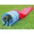 Dog demonstrating use of a blue and red agility tunnel on grass, showing the product in action for training or play purposes.