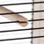 Wooden rod with semicircular profile, fixed between black metal bars of a cage.