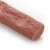 Close-up of a flesh-coloured snack stick with smooth texture and rounded ends.