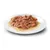 Close-up of meat pieces in gravy on a white plate, shown as an example of wet food.