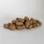 Pile of dry pet food kibble pieces shown on a plain background, displaying the size and shape of the product.