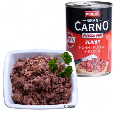 Консерва Animonda Gran Carno Fleisch Pur Senior Huhn + Putenherzen, показана до купичка с месна храна и магданоз. Видим текст: 100 %, SENIOR, Huhn + Putenherzen.