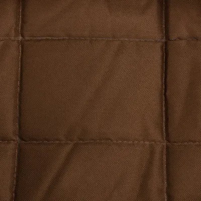 Close-up of brown quilted fabric material with visible seams.