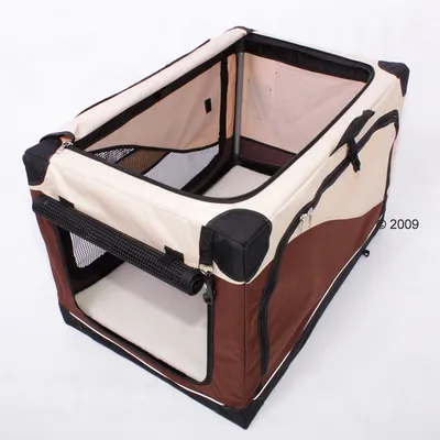 Soft-sided pet carrier in beige and brown fabric with mesh windows, zip openings on the front and side, black handles, and a removable mat inside. No visible brand name.