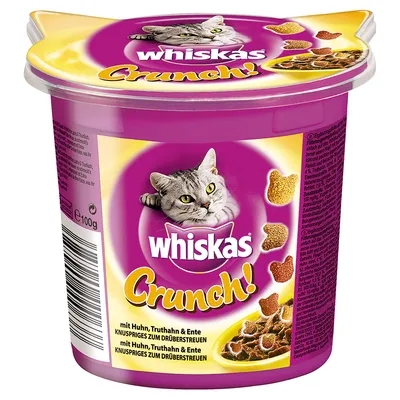 Whiskas Crunch! kattgodis, 100 g bägare. Text: mit Huhn, Truthahn & Ente, knuspriges zum drüberstreuen. Bild på grå katt och hjärtformade bitar.