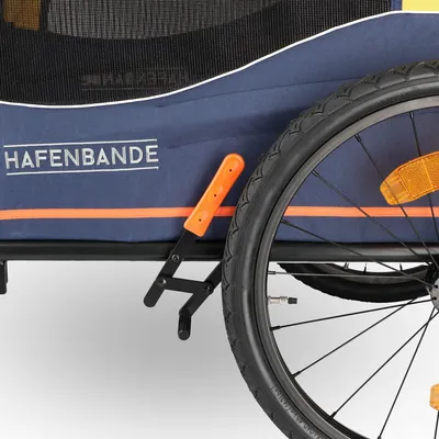 Hafenbande bicycle trailer with blue fabric, orange accents and black tyre with reflector.