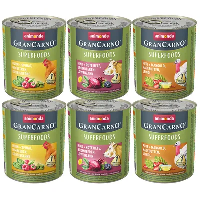 Консерви Animonda GranCarno Superfoods, видими варианти: пиле със спанак, говеждо с червено цвекло, пуешко с манголд. Видим текст на етикетите и изображения на съставки.