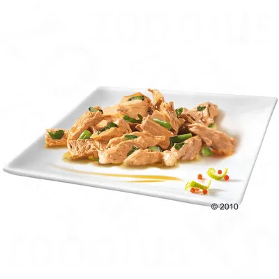 Shredded meat pieces with green vegetable chunks in gravy, served on a white square plate. No visible brand or packaging text.